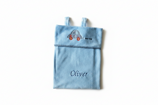 Personalised blue car seat blanket folded to show car embroidery and Oliver name, on a white background
